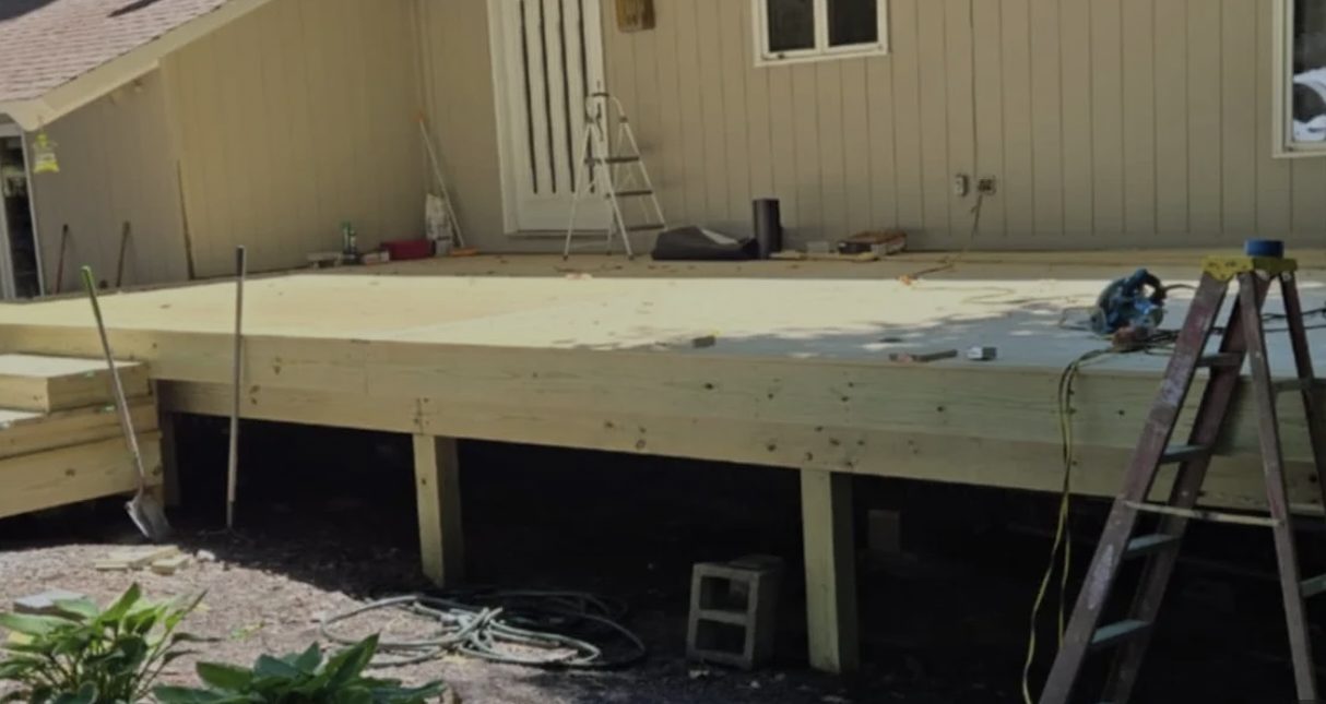Pressure-treated deck framing and decking installation in progress