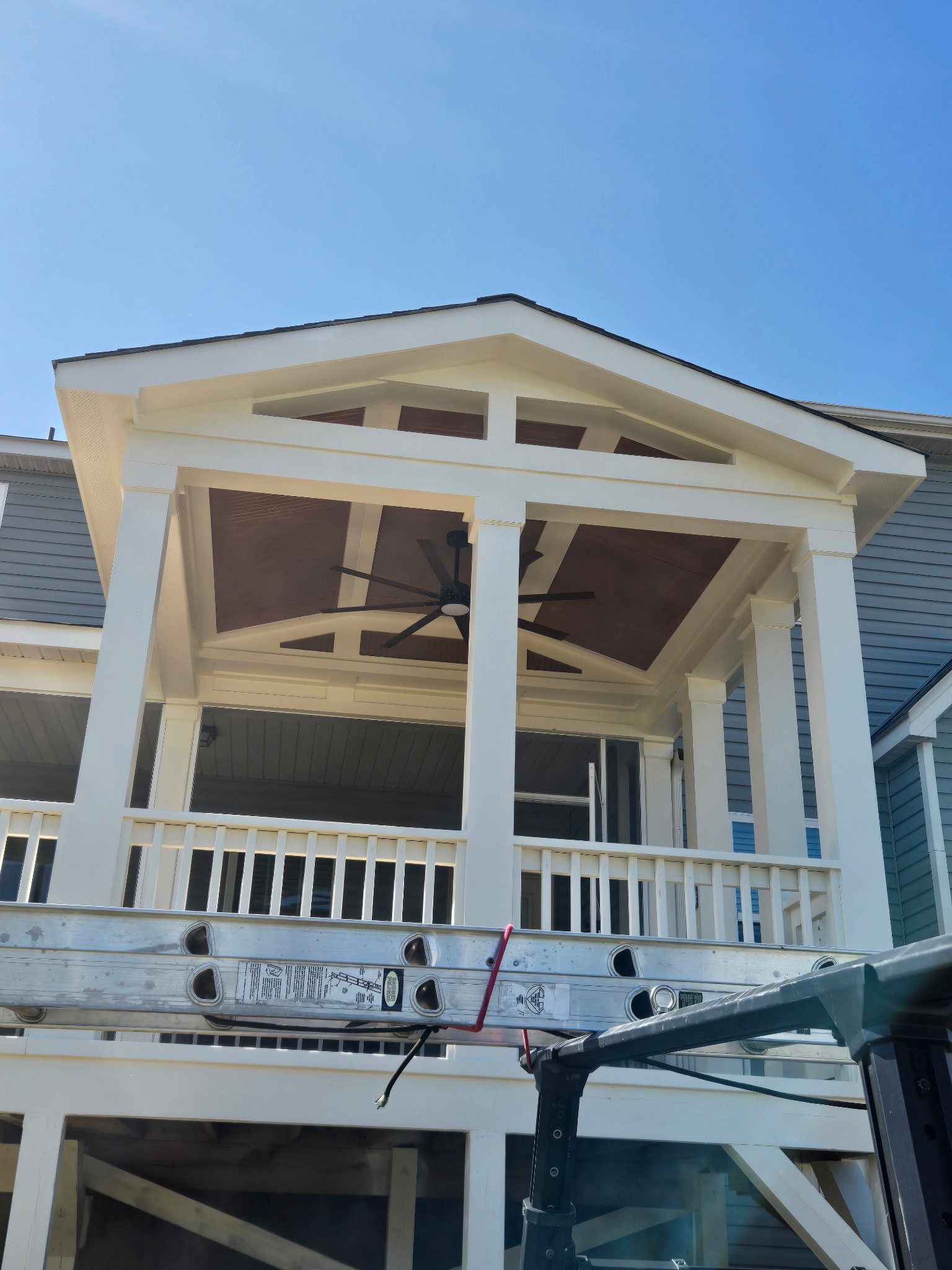Custom gable-roofed covered porch with exposed trusses